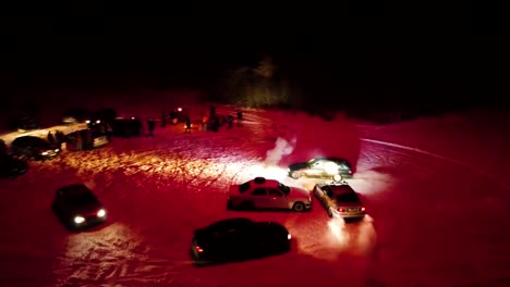 Night-time-drifting-around-car-with-fireworks-on-roof,-crowd-observe-from-side