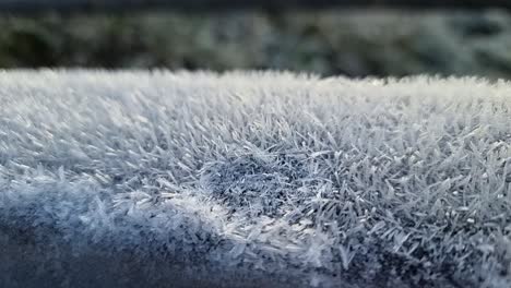 Spiky-frost-natural-pattern-close-up-coating-wooden-fence-in-cold-winter-parkland