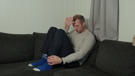 Depressed-Man-Emotional-Struggle-in-Corner-of-Sofa