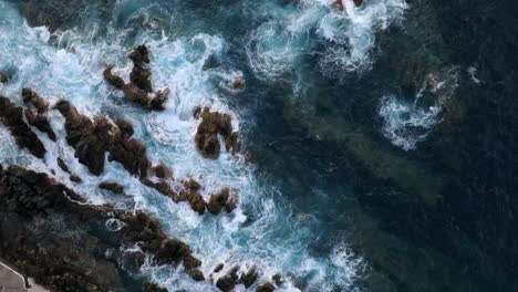 volcanic-pools-of-Porto-Moniz-in-Madeira-Portugal-footage-with-drones-of-cliffs,-ocean,-natural-bathing-spots,-and-houses-filmed-at-sunset