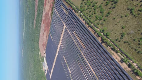 Vertical-drone-shot-of-solar-panel-park-producing-green-energy-on-Dominican-Republic-Island---Scenic-area-with-many-unit-of-photovoltaic