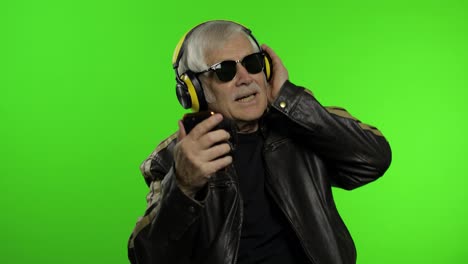 Elderly-caucasian-grandfather-biker-man-dance,-listen-music.-Chroma-key