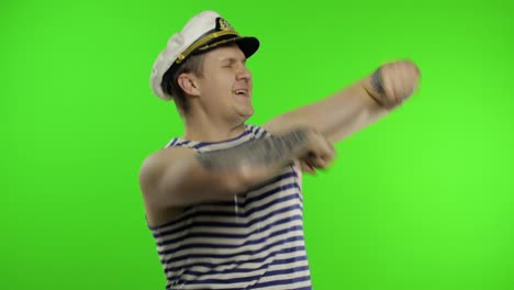 Young-sailor-man-dances-and-celebrates.-Seaman-guy-in-sailor's-vest.-Chroma-key