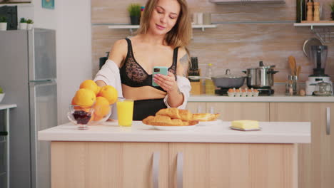 Sexy-housewife-using-smartphone
