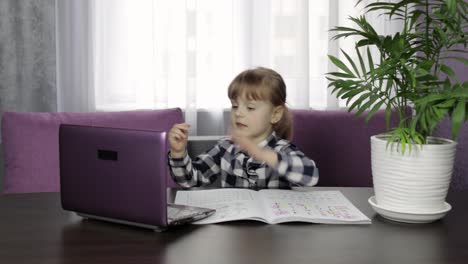 Girl-learning-online-lessons-using-digital-laptop-computer.-Distance-education