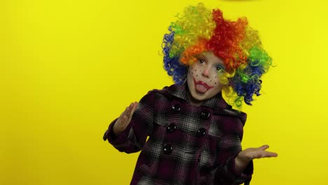 Little-child-girl-clown-in-colorful-wig-making-silly-faces,-fool-around,-smiling,-dancing.-Halloween
