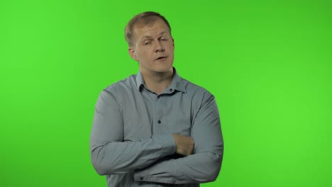 Sleepy-bored-guy-looking-at-camera-not-interested-in-communication.-Man-on-chroma-key-background
