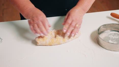 Hands-of-senior-bakery-kneading-dough
