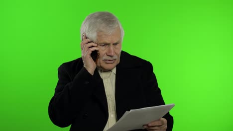 Elderly-stylish-caucasian-grandfather-man-dissatisfied-talking-on-mobile-phone