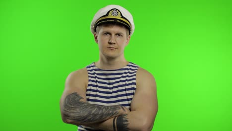 Young-sailor-man-arms-crossed,-looking-at-camera.-Seaman-guy-in-sailor's-vest