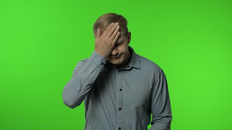 Facepalm,-fault,-omg.-Upset-distressed-man-on-chroma-key-covering-face-with-head-and-saying-no