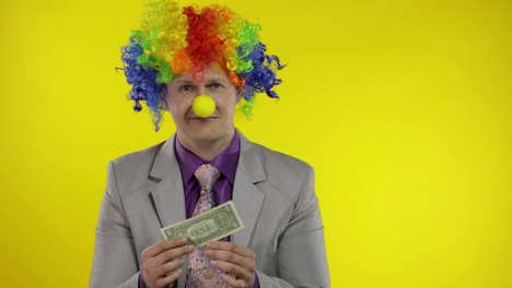 Clown-businessman-entrepreneur-in-wig-holds-one-buck-money-income-and-loses-it