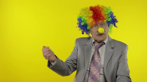 Elderly-clown-businessman-entrepreneur-boss-pointing-at-something.-Copy-space
