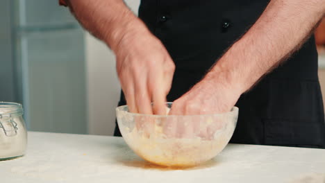 Chef-kneading-dough-in-bowl