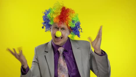 Clown-businessman-entrepreneur-in-wig-dancing,-celebrate,-making-silly-faces