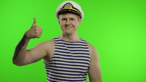 Young-sailor-man-thumbs-up,-looking-at-camera.-Seaman-guy-in-sailor's-vest