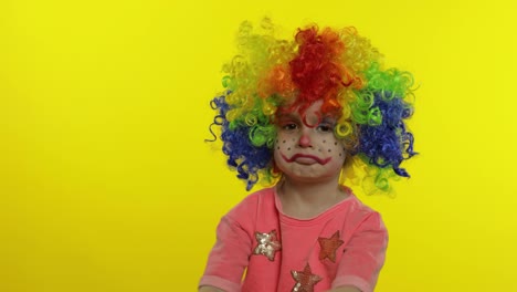 Little-child-girl-clown-in-colorful-wig-making-silly-faces,-having-fun,-smiling,-dancing.-Halloween