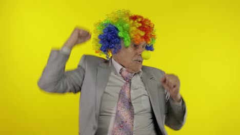 Elderly-old-clown-businessman-freelancer-dancing,-celebrate-victory,-entertains