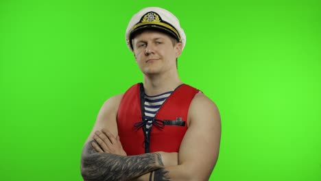Young-muscular-sailor-man-works-as-lifeguard-at-beach-show-thumbs-up.-Chroma-key