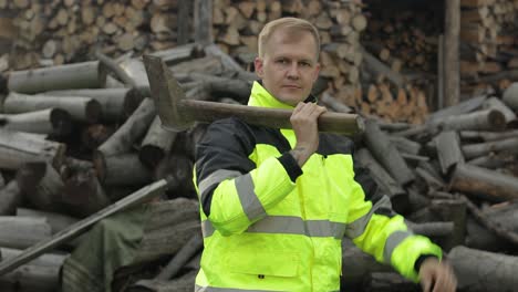 Man-lumberjack-woodcutter-with-big-axe.-Sawn-logs,-firewood-background.-Thumb-up