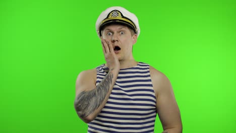 Young-sailor-man-expresses-shock,-looks-surprised.-Seaman-guy-in-sailor's-vest