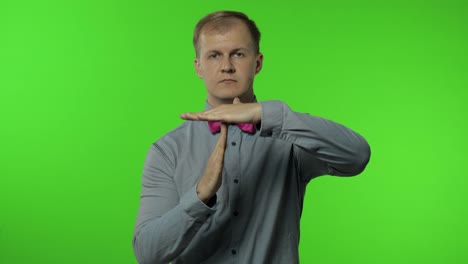 Man-showing-time-out-sign.-This-is-limit,-enough-gesture.-Portrait-of-guy-on-chroma-key-background