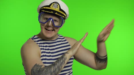 Emotional-man-tourist-in-underwater-mask,-striped-sailor-shirt-dances-celebrates