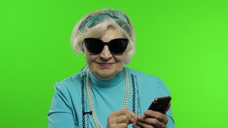 Ältere,-Stilvolle-Kaukasische-Großmutter,-Die-Die-Social-Media-App-Auf-Dem-Smartphone-Nutzt
