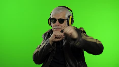 Elderly-senior-caucasian-grandfather-biker-man-dance,-listen-music.-Chroma-key