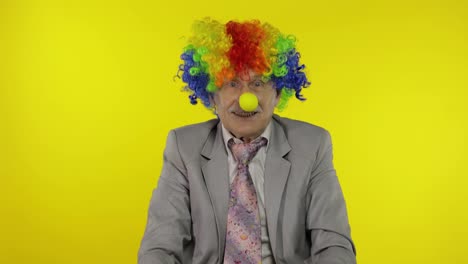 Senior-clown-businessman-entrepreneur-boss-making-silly-faces.-Expressions
