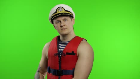 Young-muscular-sailor-man-works-as-lifeguard-at-beach-arms-crossed.-Chroma-key