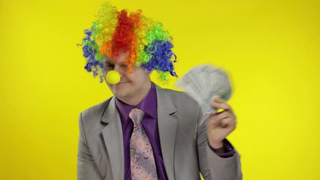 Clown-businessman-entrepreneur-boss-in-wig-with-money-banknotes-at-work