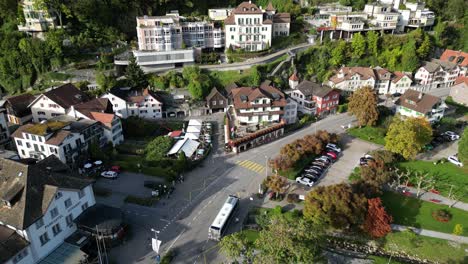 Static-aerial-shot-of-a-city-in-the-hilly-region-of-Europe-with-large-mansions-and-green-trees-around-the-place