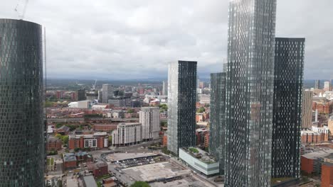 Contemporary-Manchester-Deansgate-business-district-towers-aerial-view-flying-across-city-centre-skyline