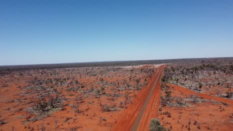 Aerial-view-of-a-deserted-country-road-and-kettle-property-in-the-Australian-Outback