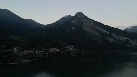Luftaufnahme-Des-Sees-Im-Tal-Rund-Um-Die-Hohen-Berggipfel-Mit-Springbrunnen-Und-Vielen-Wassersportmöglichkeiten