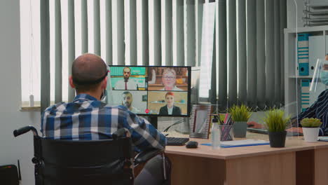 Manager-in-wheelchair-talking-with-mask-during-videocall