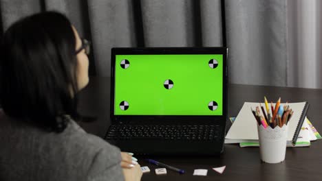Woman-teacher-making-online-distance-education-video-call-on-laptop-green-screen