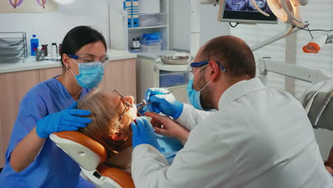 Doctor-and-nurse-preparing-patient-for-removing-crowns