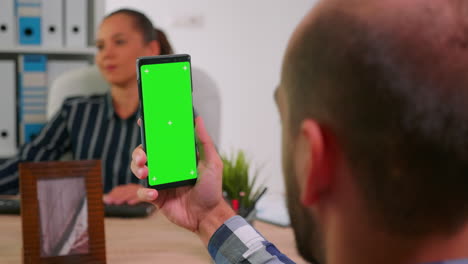 Manager-in-wheelchair-using-greenscreen-smartphone