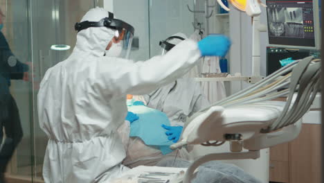 Woman-at-dentist-while-treatment-process-in-coronavirus-pandemic