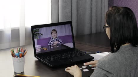 Woman-teacher-making-video-call-on-laptop-with-little-pupil.-Distance-education