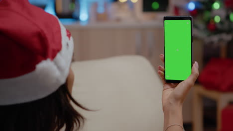 Close-up-of-adult-vertically-holding-smartphone-with-green-screen