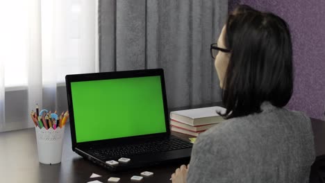 Woman-teacher-making-online-distance-education-video-call-on-laptop-green-screen