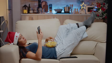 Woman-browsing-internet-on-smartphone-and-watching-television