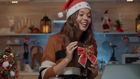 Caucasian-person-showing-wrapped-present-on-video-call