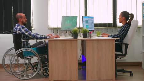 Businesswoman-talking-with-paralysed-colleague