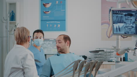 Leitender-Zahnarzt-Erklärt-Dem-Patienten-Die-Zahnradiographie