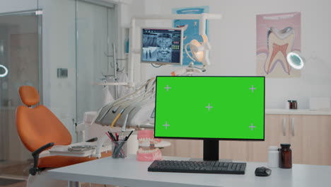 Nobody-in-stomatology-office-with-green-screen-on-computer