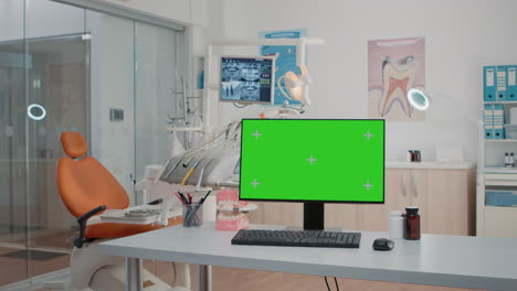 Nobody-in-dental-cabinet-with-green-screen-on-computer